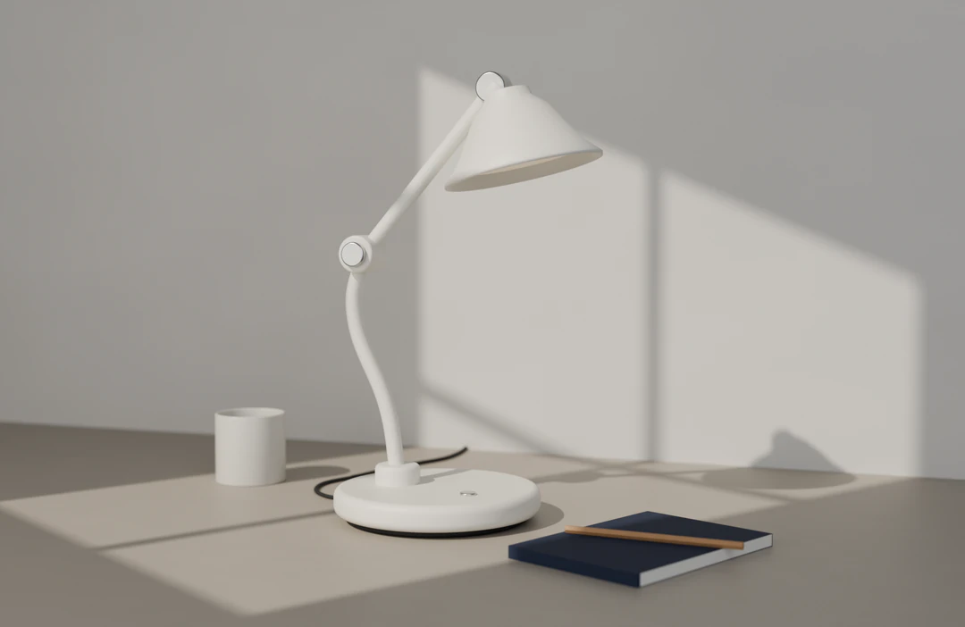 Arc 01 in chalk on a desk in morning sun, with window light and the lamp’s shadow falling on the wall behind.
