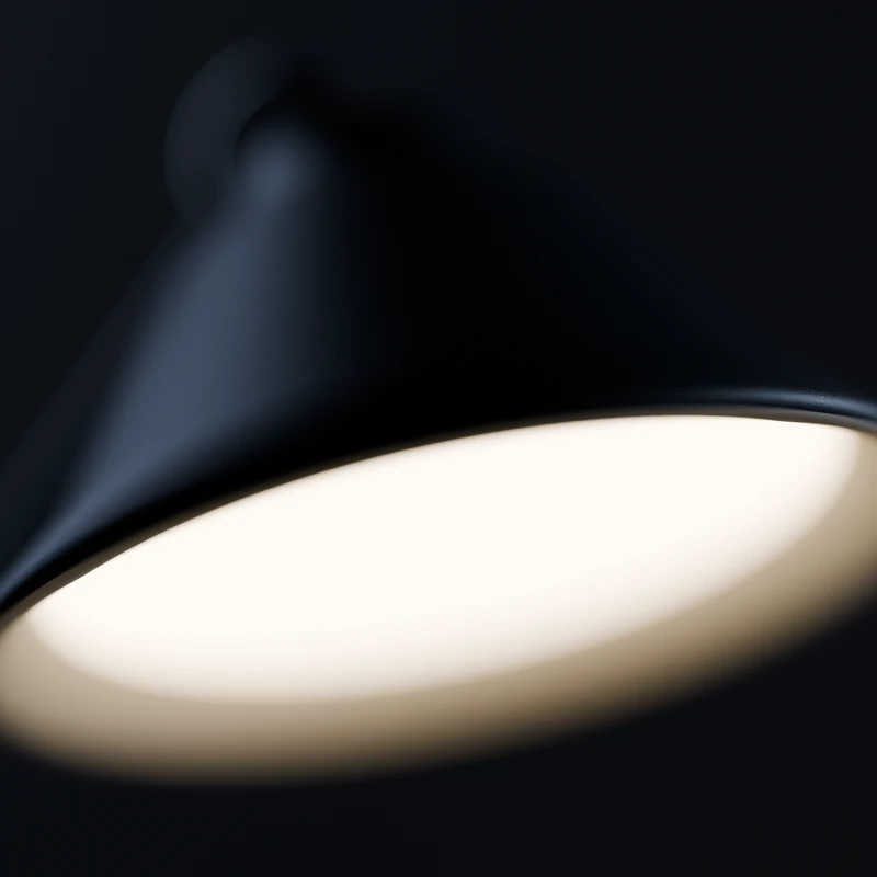 The rim of the ink shade from below, with the opal diffuser glowing inside.